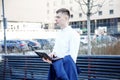 Business man. A man with a book and a laptop. The guy speaks through the phone on the street. The guy in the glasses makes notes i Royalty Free Stock Photo