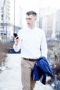 Business man. A man with a book and a laptop. The guy speaks through the phone on the street. The guy in the glasses makes notes i Royalty Free Stock Photo