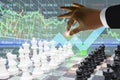 Business man manipulate stock index growth data arrow up like playng chess with candlesticks graph and chart symbol for investment