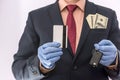 Business man in medical gloves holding credit card and car key, with money in poket, epidemic covi19 Royalty Free Stock Photo