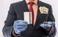 Business man in medical gloves holding credit card and car key, with money in poket, epidemic covi19 Royalty Free Stock Photo