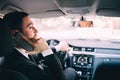 Business Man with mobile phone while driving a car. Royalty Free Stock Photo