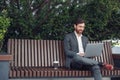 Business man office worker working on laptop in urban park background Royalty Free Stock Photo