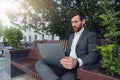 Business man office worker working on urban park background using laptop Royalty Free Stock Photo