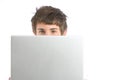 A business man peeking over a modern laptop Royalty Free Stock Photo