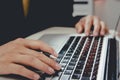 Business man with a pen on a notebook computer keyboard Royalty Free Stock Photo