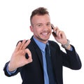 Business man on the phone shows ok Royalty Free Stock Photo