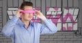 Business man in pink virtual reality headset against grey and pink hand drawn windows