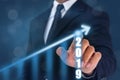 Business man point hand on the top of arrow graph with high rate of growth. The success and growing growth graph in the company or Royalty Free Stock Photo