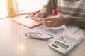 Business man pointing on data paper data work on office table with laptop.Concept business and finance.