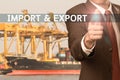 Business man pointing finger to word import & export