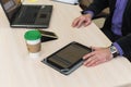 Business man portrait with laptop and coffee at the table. Tablet on the table with work schedules.