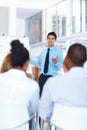 Business man presenting at office. Portrait of young business man giving presentation at meeting. Royalty Free Stock Photo