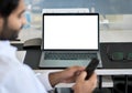 Business man working with mock up laptop white screen on background. Royalty Free Stock Photo