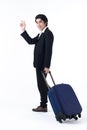 A business man pulling luggage and waving hand Royalty Free Stock Photo