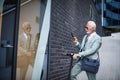 Man with push scooter on street using smart phone Royalty Free Stock Photo