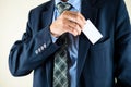 Business man putting business card in a pocket with copyspace, m Royalty Free Stock Photo