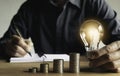 Business man putting a coin on coins stack saving bank and account for his money all in finance accounting concept Royalty Free Stock Photo