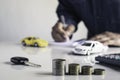 Business man putting a coin on coins stack saving bank and account for his money all in finance accounting concept Royalty Free Stock Photo