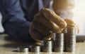 Business man putting  a coin on coins stack saving bank and account for his money all in finance accounting concept Royalty Free Stock Photo