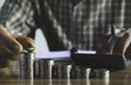 Business man putting  a coin on coins stack saving bank and account for his money all in finance accounting concept Royalty Free Stock Photo