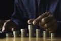 Business man putting  a coin on coins stack saving bank and account for his money all in finance accounting concept Royalty Free Stock Photo