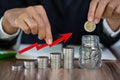 Business man putting coin in glass bottle saving bank and account for his money all in finance accounting, account and saving Royalty Free Stock Photo