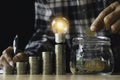 Business man putting a coin on coins stack saving bank and account for his money all in finance accounting concept Royalty Free Stock Photo