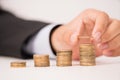 Business man putting stack of coins Royalty Free Stock Photo