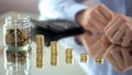 Business man putting stack of coins into one row, increasing profit, finance Royalty Free Stock Photo