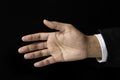 Business Man reaches out a hand on a black background