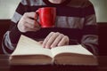 Business man reading book with coffee in coffee shop. Royalty Free Stock Photo