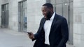 Business man reading good news on cellphone. Entrepreneur celebrating victory Royalty Free Stock Photo