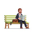 Business man reading newspaper sitting on a bench Royalty Free Stock Photo