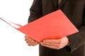 Business man reading from a red folder Royalty Free Stock Photo