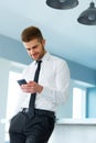 Business Man Reading Something on the Screen of His Cell Phone Royalty Free Stock Photo