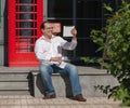 Business man on red classic English telephone box Royalty Free Stock Photo