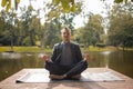 Business man relaxing in a park in the lotus position. businessman do yoga exercise outdoor. Royalty Free Stock Photo