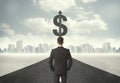 Business man on road heading toward a dollar sign Royalty Free Stock Photo