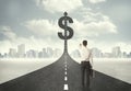 Business man on road heading toward a dollar sign Royalty Free Stock Photo