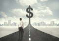 Business man on road heading toward a dollar sign Royalty Free Stock Photo