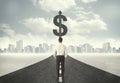 Business man on road heading toward a dollar sign Royalty Free Stock Photo