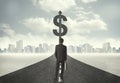 Business man on road heading toward a dollar sign Royalty Free Stock Photo