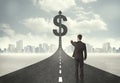 Business man on road heading toward a dollar sign Royalty Free Stock Photo