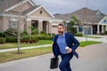 Business man run near house in american neighborhood. Businessman run down street, late for a meeting. Businessman in Royalty Free Stock Photo