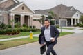 Business man run near house in american neighborhood. Businessman run down street, late for a meeting. Businessman in Royalty Free Stock Photo