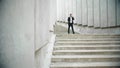 Business man running for work on street. Male entrepreneur calling on smartphone Royalty Free Stock Photo