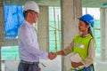 Business man is shaking hand with his operator after meeting in building site