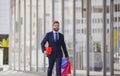 Business man shopping in a shopping center. Happy businessman in suit holding paperbags. Shopaholic man walking on Royalty Free Stock Photo