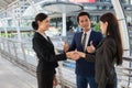 Business man show thumb up and two business woman shaking hands for demonstrating their agreement to sign agreement or contract Royalty Free Stock Photo